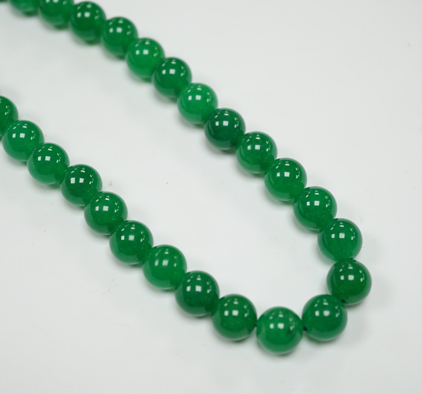 A single strand jade bead necklace, with white metal clasp, 42cm.